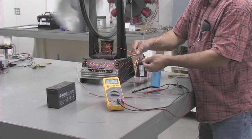 Electrician Using Multimeter for Circuit Repair